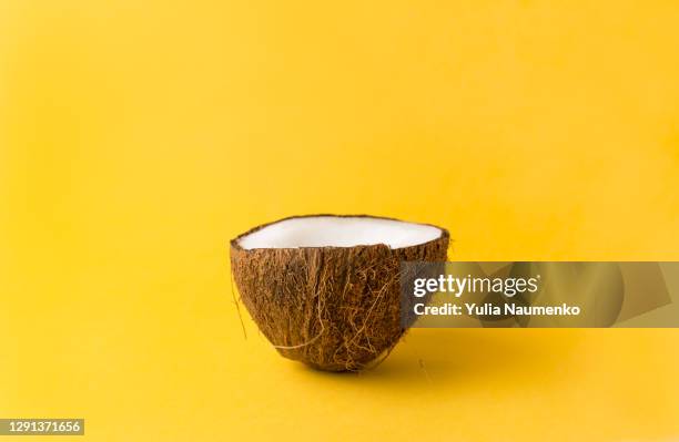 coconut on yellow backgroun. summer concept. - kokosnüsse stock-fotos und bilder