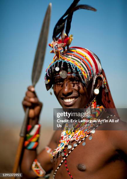 Portrait of a smiling Samburu tribe warrior with beaded headwear, Samburu County, Maralal, Kenya on July 8, 2009 in Maralal, Kenya.