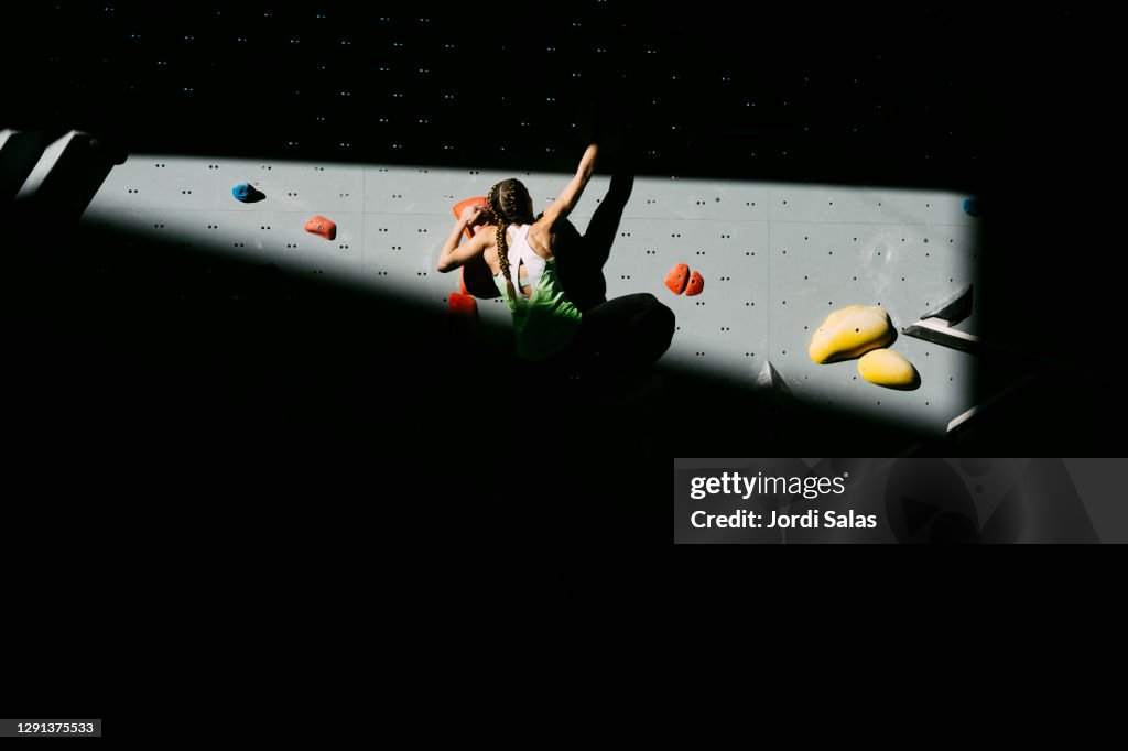 Climber woman climbing a wall