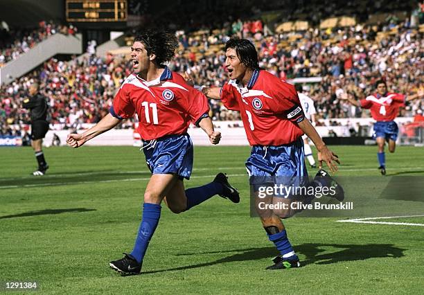 Marcelo Salas of Chile celebrates with team mate Ivan Zamorano after scoring in the World Cup group B game against Italy at the Parc Lescure in...