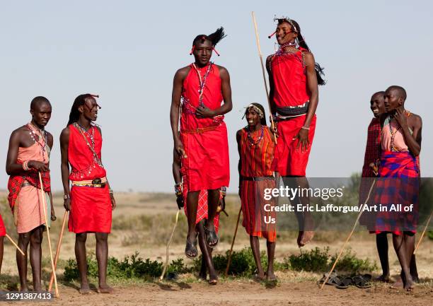 Maasai tribe men jumping during a ceremony, Rift Valley Province, Maasai Mara, Kenya on July 8, 2009 in Maasai Mara, Kenya.