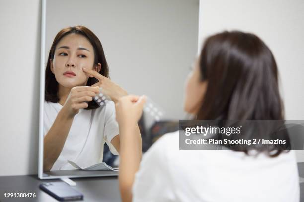 a woman having a trouble on skin - pimple stock pictures, royalty-free photos & images