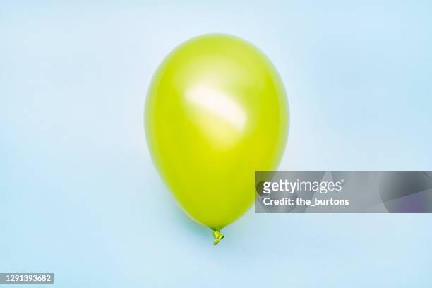 high angle view of a green balloon on blue background - german greens party stock pictures, royalty-free photos & images