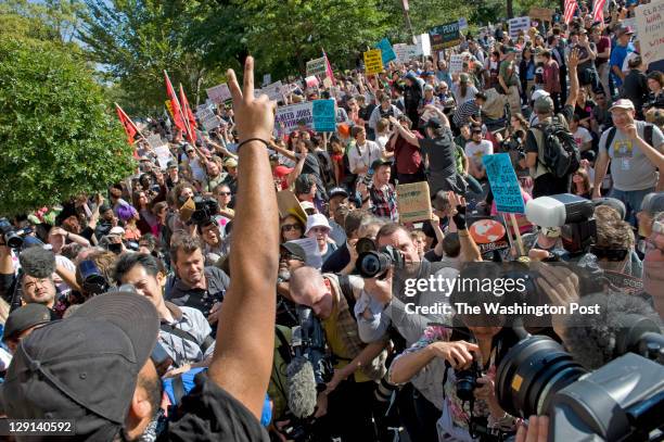 Protestors listen to a speech at the "Occupy Wall Street" protest and march to the US Chamber of Commerce in Washington, DC on October 6, 2011. They...