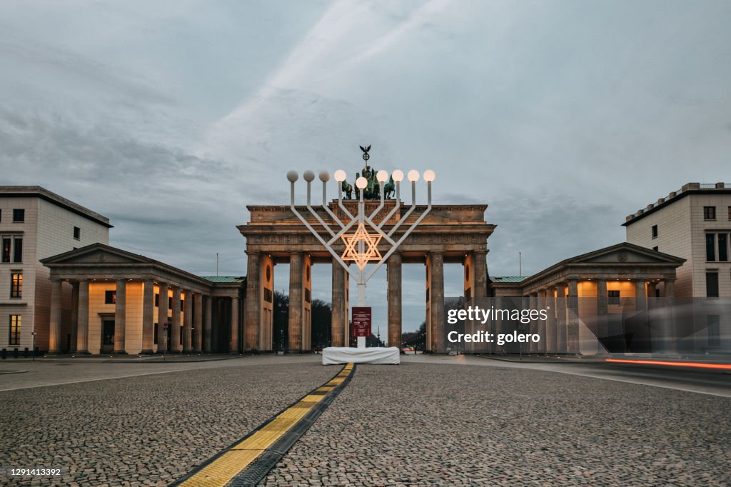Illuminated menorah symbol in front of Brandenburg gate in Berlin