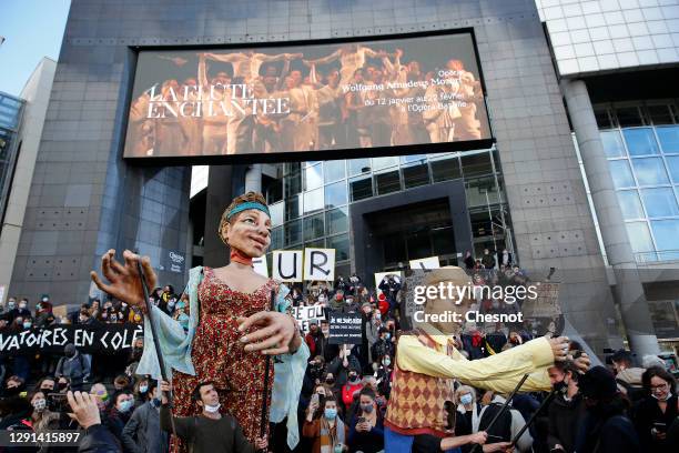 Giant puppets animated by comedians from the cultural sector attend a demonstration in front of the Opera Bastille to protest against the measures of...