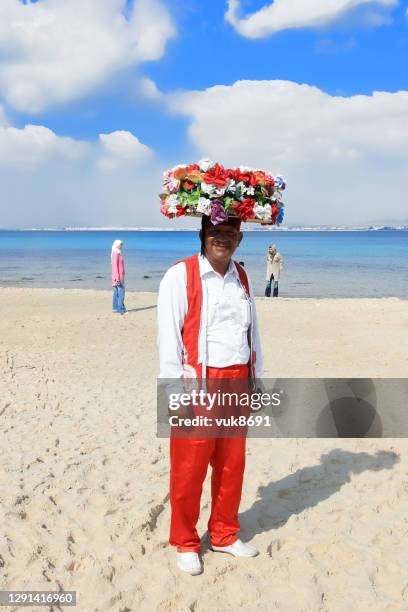 posing  in a traditional tunisian costume - hammamet beach stock pictures, royalty-free photos & images