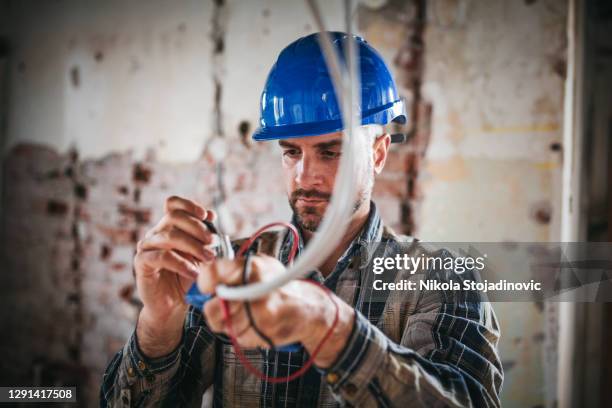 an electrical engineer connects the electricity - fiber optic cable stock pictures, royalty-free photos & images