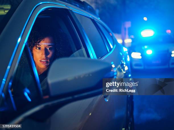 nightime police traffic stop - pulled over by police stock pictures, royalty-free photos & images