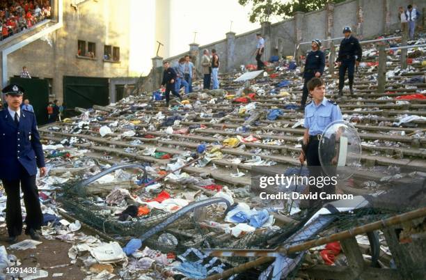 Ground staff clear the aftermath of the Heysel disaster after the European Cup Final between Liverpool and Juventus at the Heysel Stadium in...