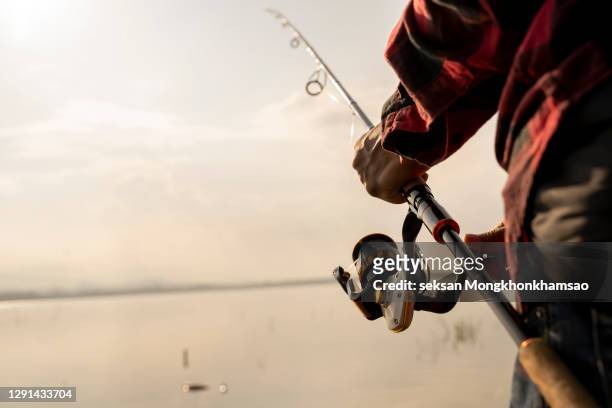 fishing on the lake at sunset. fishing background. - fishing rod bildbanksfoton och bilder