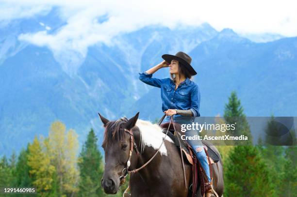 woman riding her horse at a ranch - western canada farm stock pictures, royalty-free photos & images