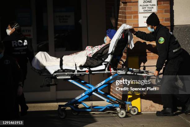 Medical workers tend to a patient at a Brooklyn hospital that has seen a rise in coronavirus-related cases on December 15, 2020 in New York City....