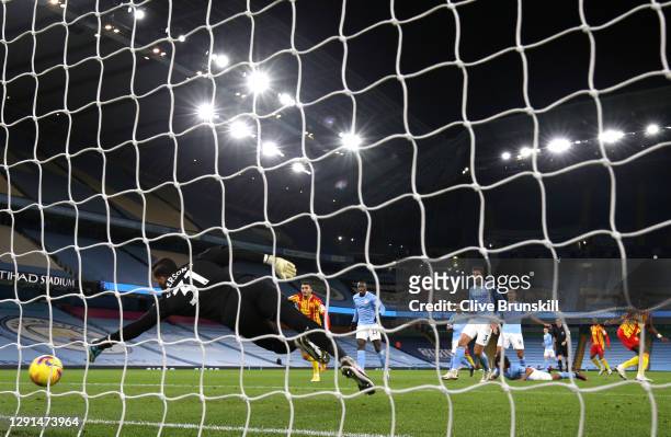 Ederson of Manchester City dives for the ball as Ruben Dias of Manchester City scores an own goal for West Bromwich Albion's first during the Premier...