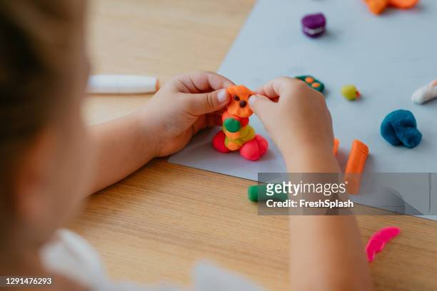 unrecognizable girl playing with plasticine - clay stock pictures, royalty-free photos & images