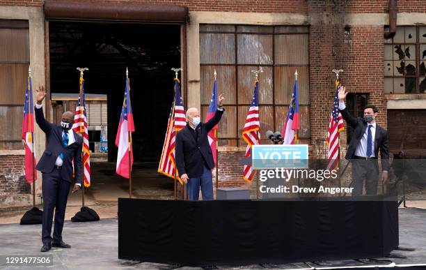 President-elect Joe Biden, and U.S. Democratic Senate candidates Jon Ossoff and Rev. Raphael Warnock wave to the crowd during a drive-in rally at...