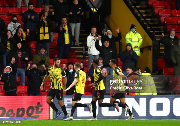 Troy Deeney of Watford celebrates with teammates Tom Cleverley, Nathaniel Chalobah and William Troost-Ekongafter scoring their team's first goal...