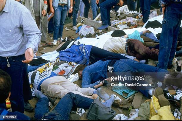 Bodies litter the ground after the crowd riots during the European Cup match between Liverpool and Juventus at the Heysel Stadium in Brussels,...