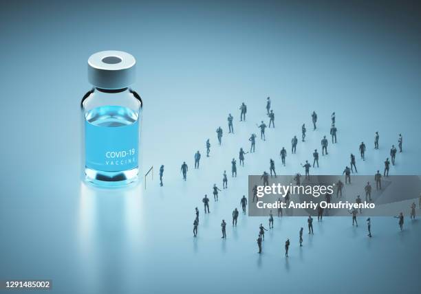 people waiting in line for covid-19 vaccine. - lining up for vaccine stock pictures, royalty-free photos & images