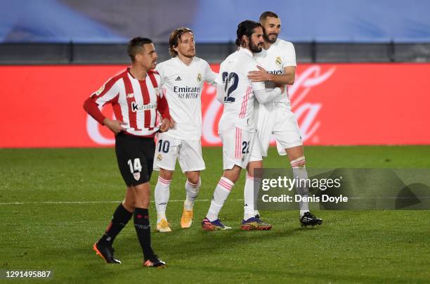 Karim Benzema of Real Madrid celebrates with Luka Modric and Isco after scoring his sides third goal as Dani Garcia of Athletic Bilbao reacts during...