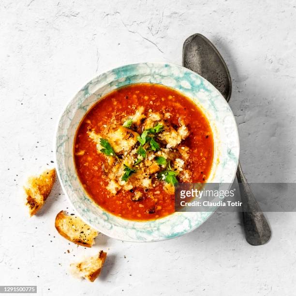 bowl of tomato soup on white background - tomato soup ストックフォトと画像