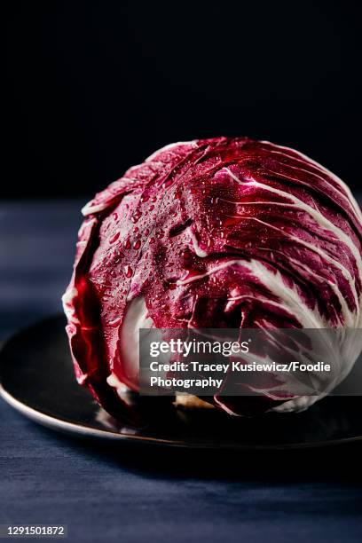 whole head of red radicchio - radicchio stock pictures, royalty-free photos & images