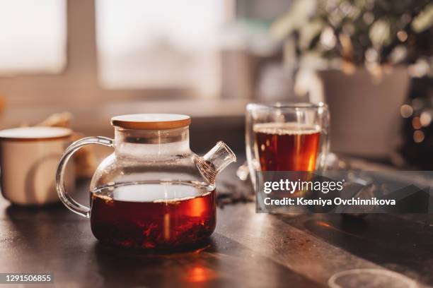 process brewing tea,tea ceremony,cup of freshly brewed black tea,warm soft light, darker background. - steeping stock pictures, royalty-free photos & images