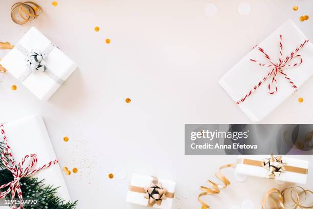 top view of elegant gift boxes and confetti placed on gray background. happy holidays of the year - flat lay stock-fotos und bilder