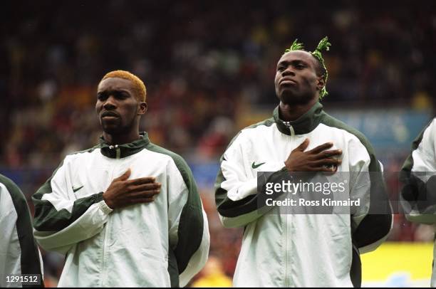 Jay-Jay Okocha and Taribo West of Nigeria line up for the national anthem before the World Cup group D game against Spain at the Stade de la...