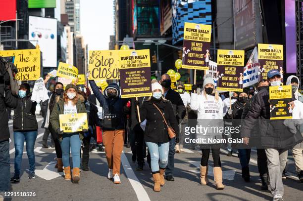 Restaurant owners and workers protest in Times Square against new regulations that ended indoor dining on December 15, 2020 in New York City. People...