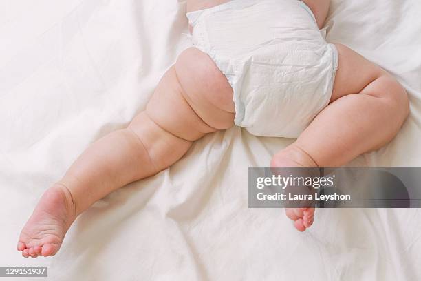 baby wearing diaper - baby close up bed stock pictures, royalty-free photos & images
