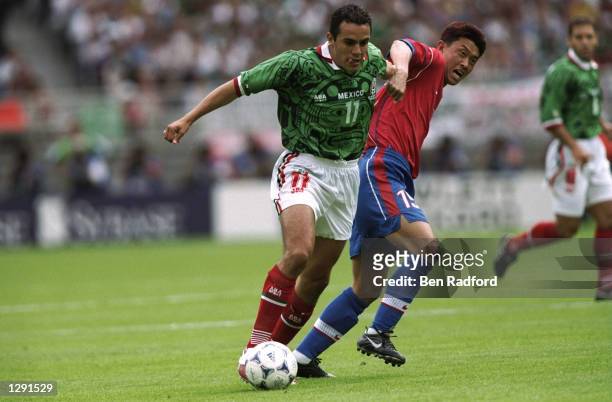 Cuauhtemoc Blanco of Mexico goes past Jang Dae-Il of South Korea during the World Cup group E game at the Stade Gerland in Lyon, France. Mexico won...