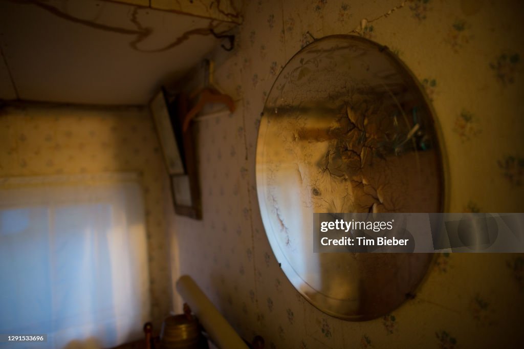 Old mirror with cracks and muted reflections