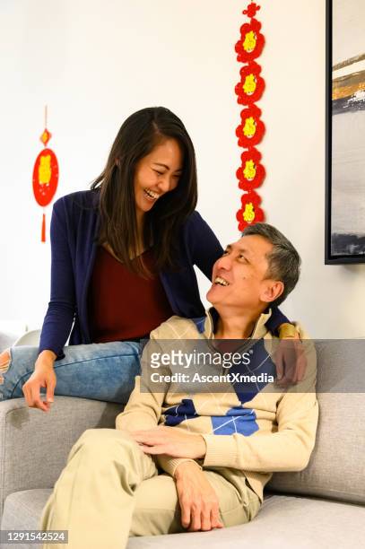 family celebrating chinese new years at home - 30 34 years stock pictures, royalty-free photos & images