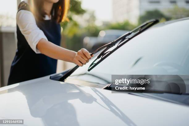 young asian woman checking windshield wiper - adjusting stock pictures, royalty-free photos & images