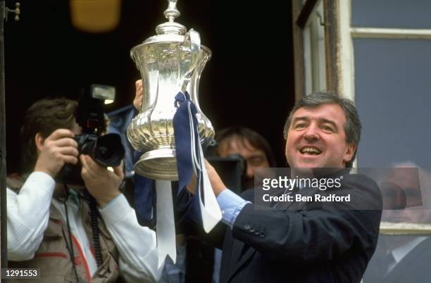 Terry Venables the manager of Tottenham Hotspur holds the trophy aloft during the homecoming after winning the FA Cup Final against Nottingham Forest...