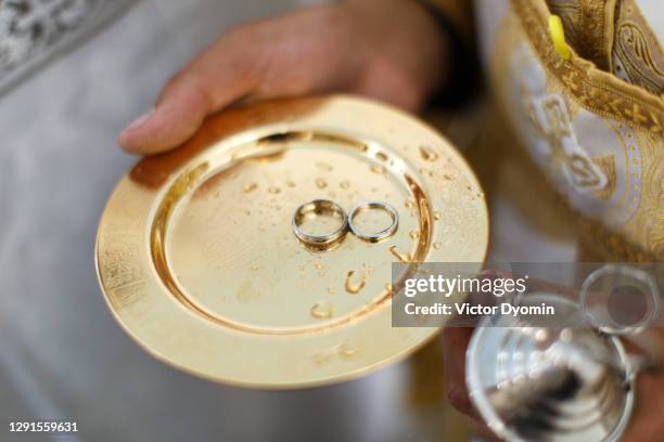 pair of the wedding rings at the golden plate - married church stock pictures, royalty-free photos & images