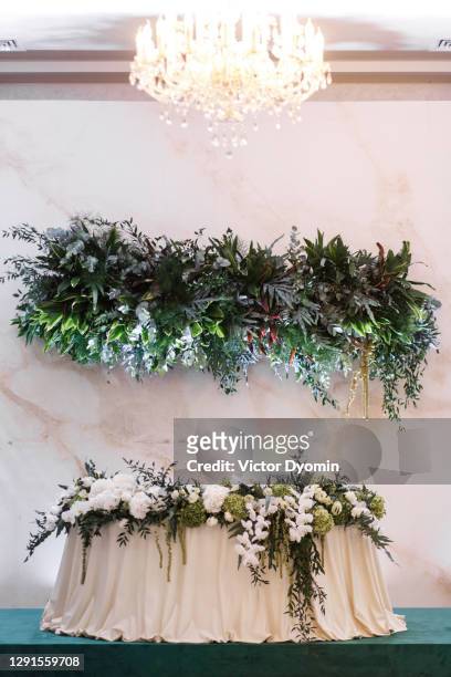 stylishly decorated separated table for the newlyweds - big wedding reception stock pictures, royalty-free photos & images