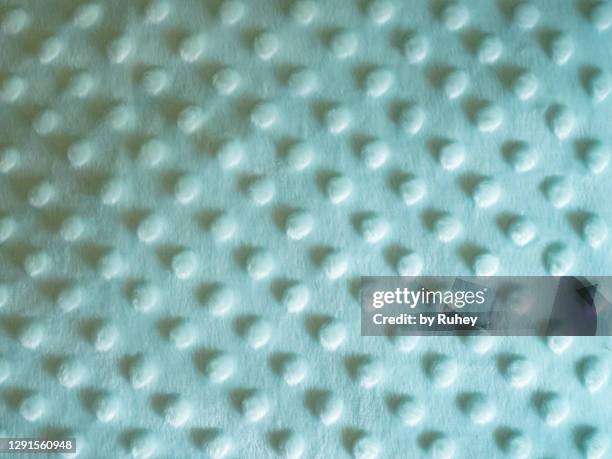 textile background of a green blanket with dots making geometric shapes - newly industrialized country stock pictures, royalty-free photos & images