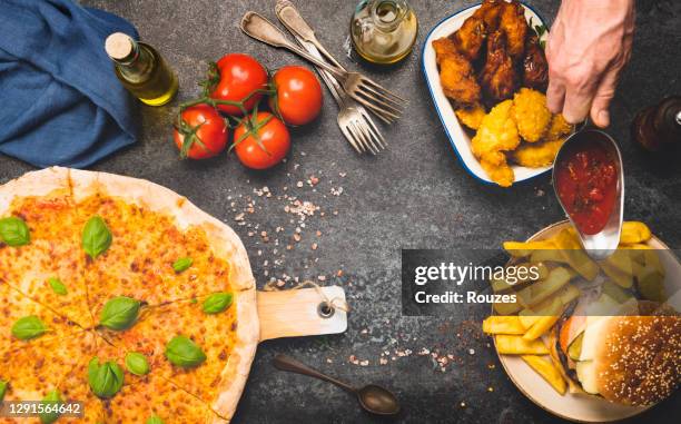 friends having pizza at party - eating chicken nuggets stock pictures, royalty-free photos & images