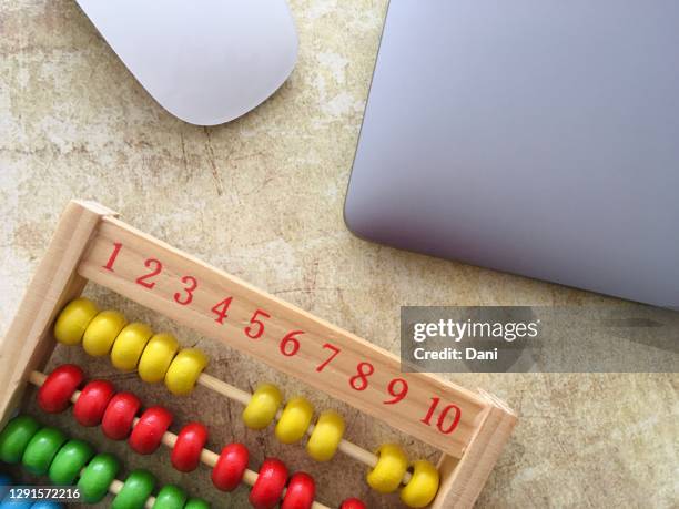 overhead view of an abacus next to a laptop and computer mouse - abacus computer stock pictures, royalty-free photos & images