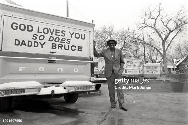Daddy Bruce” Randolph, restaurateur and philanthropist who founded the city’s annual “Daddy Bruce Thanksgiving Food Distribution”, stands next to a...