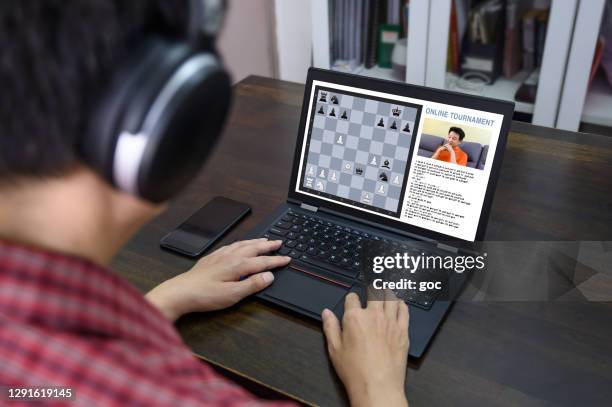 mid asian adult participating and competing in online chess tournament - chess championship stock pictures, royalty-free photos & images