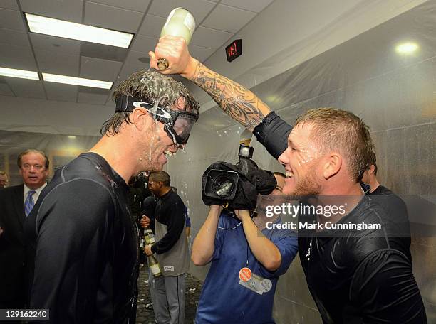 Doug Fister and Ryan Perry of the Detroit Tigers celebrate in the locker room after their victory against the New York Yankees during Game Five of...