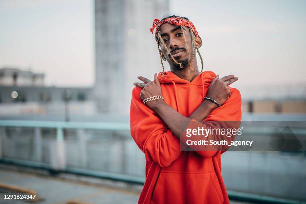 portrait of young gangsta rapper outdoors in the city - rapper stock pictures, royalty-free photos & images