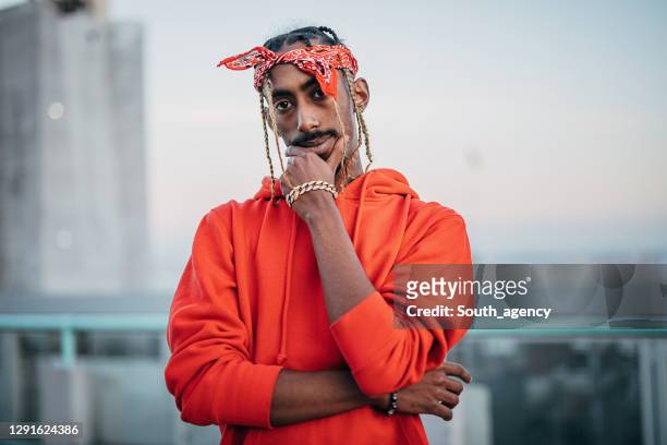 portrait of one gangsta rapper outdoors in the city - rapper stock pictures, royalty-free photos & images