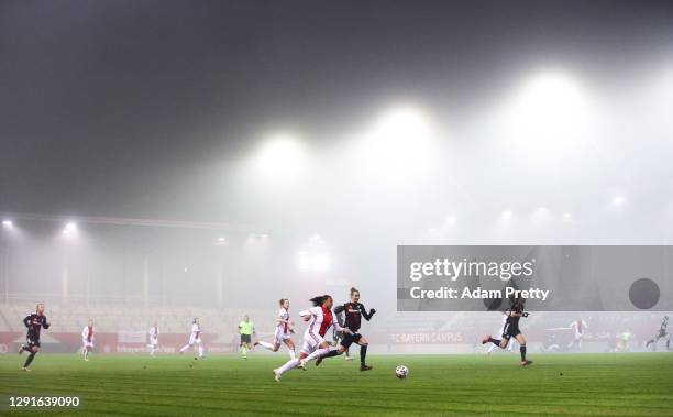 Chastity Grant of AFC Ajax is challenged by Simone Laudehr of FC Bayern Muenchen during the UEFA Women's Champions League round of 32 second leg...
