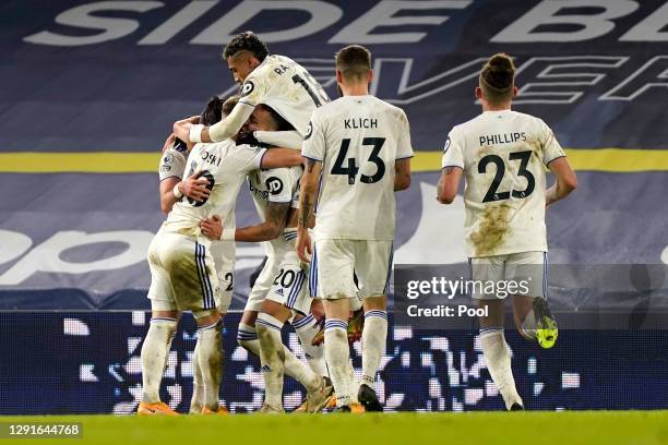 Rodrigo Moreno of Leeds United celebrates with teammates Jack Harrison, Raphinha and Ezgjan Alioski after scoring their team's second goal during the...