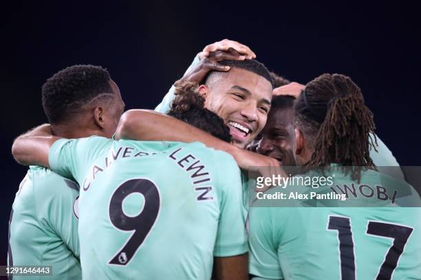 Mason Holgate of Everton celebrates with teammates Yerry Mina, Dominic Calvert-Lewin and Alex Iwobi after scoring their team's second goal during the...