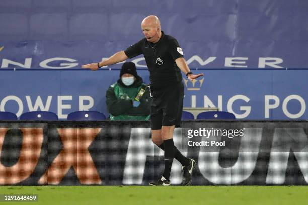 Match referee Lee Mason gestures to disallow a penalty decision after checking the pitch side VAR screen during the Premier League match between...